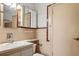 Classic bathroom with vintage charm, featuring pink tile, vanity, toilet and mirrored cabinet at 101 Pampas Ave, Tarpon Springs, FL 34689