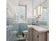 Charming bathroom featuring retro blue tile, a toilet, a sink and large mirrored cabinet at 101 Pampas Ave, Tarpon Springs, FL 34689