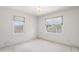 Bright bedroom featuring two windows, offering natural light and views of the neighborhood at 101 Pampas Ave, Tarpon Springs, FL 34689