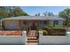 Charming home with a gated entrance, beautiful landscaping, and an inviting pergola at 101 Pampas Ave, Tarpon Springs, FL 34689