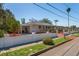 Single-story home with a white fence, attached carport, and well-kept landscaping, offering a welcoming curb appeal at 101 Pampas Ave, Tarpon Springs, FL 34689