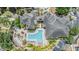 Stunning aerial view of community pool, lush landscaping, and ample parking, highlighting a luxurious living experience at 10103 Courtney Oaks Cir # 103, Tampa, FL 33619