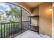Cozy balcony featuring stone accents, a view of the neighborhood, and a convenient metal storage rack at 10103 Courtney Oaks Cir # 103, Tampa, FL 33619