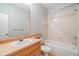 Bathroom with a tub, shower, single sink vanity and large mirror at 10103 Courtney Oaks Cir # 103, Tampa, FL 33619