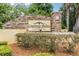 Community sign with stone base and manicured landscaping at 10103 Courtney Oaks Cir # 103, Tampa, FL 33619
