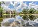 Picturesque view of the pond reflecting blue skies, creating a peaceful atmosphere in the community at 10103 Courtney Oaks Cir # 103, Tampa, FL 33619