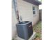 HVAC unit on a concrete slab, installed next to the side of the house with a small window at 10106 66Th Ave, Seminole, FL 33772