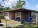 Single story house with covered carport, fenced yard, and an exterior storage area at 10106 66Th Ave, Seminole, FL 33772