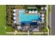 Aerial view of community pool area with ample seating, umbrellas, and lush landscaping at 10218 Purple Leaf Ct, Riverview, FL 33578