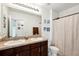Bathroom featuring a double vanity with modern fixtures, a large mirror, and neutral tones at 10230 Geese Trail Cir, Sun City Center, FL 33573