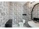 Half bath with unique wallpaper, toilet, and sink at 10230 Geese Trail Cir, Sun City Center, FL 33573