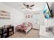 Cute bedroom with Hello Kitty decor, a plush bed, and a wall-mounted TV at 10230 Geese Trail Cir, Sun City Center, FL 33573