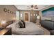 A bedroom featuring a ceiling fan, chandelier, and television at 10230 Geese Trail Cir, Sun City Center, FL 33573
