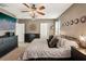 A bedroom featuring a ceiling fan, chandelier, and television at 10230 Geese Trail Cir, Sun City Center, FL 33573