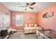 Cozy bedroom, decorated with Winnie the Pooh, features a neutral toned carpet and a ceiling fan at 10230 Geese Trail Cir, Sun City Center, FL 33573