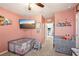 Playful bedroom features a television, play sets, themed wall décor, and a gray carpet at 10230 Geese Trail Cir, Sun City Center, FL 33573
