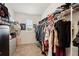 Walk-in closet with shelving and clothing at 10230 Geese Trail Cir, Sun City Center, FL 33573