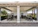 Outdoor dining area in a community featuring tables and chairs under a covered pavilion at 10230 Geese Trail Cir, Sun City Center, FL 33573