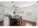 Dining area with modern light fixture, hardwood floors, and large window at 10230 Geese Trail Cir, Sun City Center, FL 33573