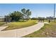 Grassy dog park offering walking paths, benches and a pet waste station for community residents at 10230 Geese Trail Cir, Sun City Center, FL 33573