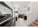 Inviting foyer featuring a large mirror, white tile flooring, and staircase at 10230 Geese Trail Cir, Sun City Center, FL 33573