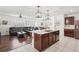 Open kitchen with stainless steel appliances and a dark wood island at 10230 Geese Trail Cir, Sun City Center, FL 33573