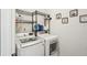 Functional laundry room with modern washer and dryer, shelving, and laundry-themed wall decor at 10230 Geese Trail Cir, Sun City Center, FL 33573