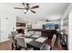 Open-concept with dining area, large leather sectional and hardwood floors at 10230 Geese Trail Cir, Sun City Center, FL 33573