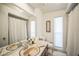 Bathroom with a large mirror, light fixtures and a neutral-toned color palette at 1137 86Th N Ave, St Petersburg, FL 33702