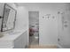 Bright bathroom with a tiled shower and view into the bedroom at 1137 86Th N Ave, St Petersburg, FL 33702