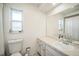 Clean bathroom with white fixtures, a marble countertop, and ample natural light at 1137 86Th N Ave, St Petersburg, FL 33702