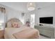 This bedroom showcases a woven headboard, neutral tones, and modern dresser at 1137 86Th N Ave, St Petersburg, FL 33702
