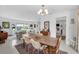 Open-concept dining area with stylish chandelier and an inviting view into the bright living room at 1137 86Th N Ave, St Petersburg, FL 33702