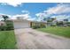 Charming home with an attached two-car garage, established landscaping, and a long driveway at 1137 86Th N Ave, St Petersburg, FL 33702