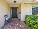 Inviting front porch featuring brick flooring and a black front door, complete with a welcome mat at 1137 86Th N Ave, St Petersburg, FL 33702