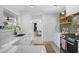 Bright kitchen with white cabinets, marble countertops, designer hardware, stainless appliances, and eat-in bar at 1137 86Th N Ave, St Petersburg, FL 33702