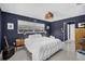 Serene main bedroom with dark walls, a large window, soft lighting, and stylish decor at 1137 86Th N Ave, St Petersburg, FL 33702