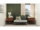 Stylish Bedroom with a black crib, dark green accent wall, and modern decor at 11547 E 71St Ter, Palmetto, FL 34221