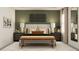 Stylish bedroom with warm colors, a textured accent wall, and elegant bedside lighting at 11547 E 71St Ter, Palmetto, FL 34221