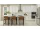 Bright kitchen with stainless steel appliances, white cabinets, a kitchen island, and bar stool seating at 11547 E 71St Ter, Palmetto, FL 34221
