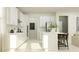 Bright kitchen with stainless steel appliances, white cabinets, a kitchen island, and bar stool seating at 11547 E 71St Ter, Palmetto, FL 34221