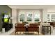 Comfortable living room with stylish decor, a patterned rug, and a view of the outdoors through large windows at 11547 E 71St Ter, Palmetto, FL 34221