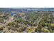 Aerial view of a residential neighborhood with mature trees, city skyline, and waterways at 1175 Jackson Rd, Clearwater, FL 33755