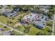 Aerial view shows property's well-manicured lawn and gardens surrounded by palm trees and residential neighborhood at 1175 Jackson Rd, Clearwater, FL 33755