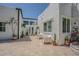 Private backyard with white stucco walls, potted plants, and outdoor seating area at 1175 Jackson Rd, Clearwater, FL 33755