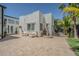 Backyard with white stucco walls, potted plants, a fountain, and comfortable outdoor seating at 1175 Jackson Rd, Clearwater, FL 33755