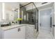 Modern bathroom features a glass enclosed shower and a countertop with decorative accents at 1175 Jackson Rd, Clearwater, FL 33755