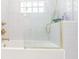 White bathroom with glass shower door and gold fixtures exudes modern elegance at 1175 Jackson Rd, Clearwater, FL 33755