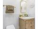 Bright bathroom boasts a custom vanity and gold accents against the white tile at 1175 Jackson Rd, Clearwater, FL 33755