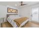 Cozy bedroom featuring a stylish bed, wooden floors, and a bright window, radiating comfort at 1175 Jackson Rd, Clearwater, FL 33755